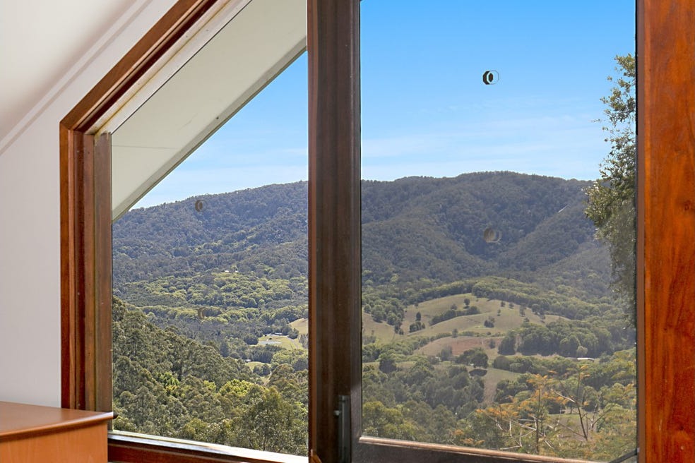 Valley view through timber-framed windows
