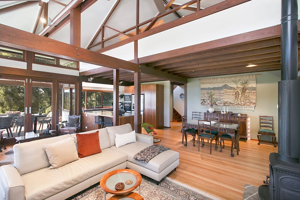 Open-plan living and dining beneath the timber ceiling