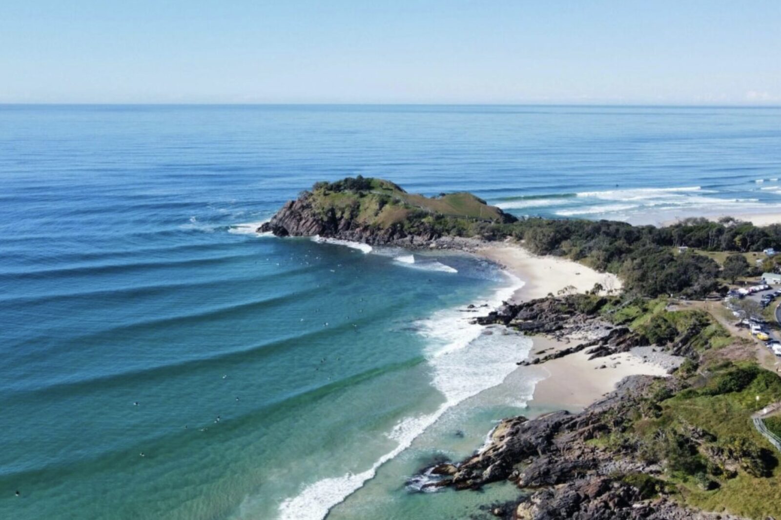 A sweeping beach framed by a coastal headland