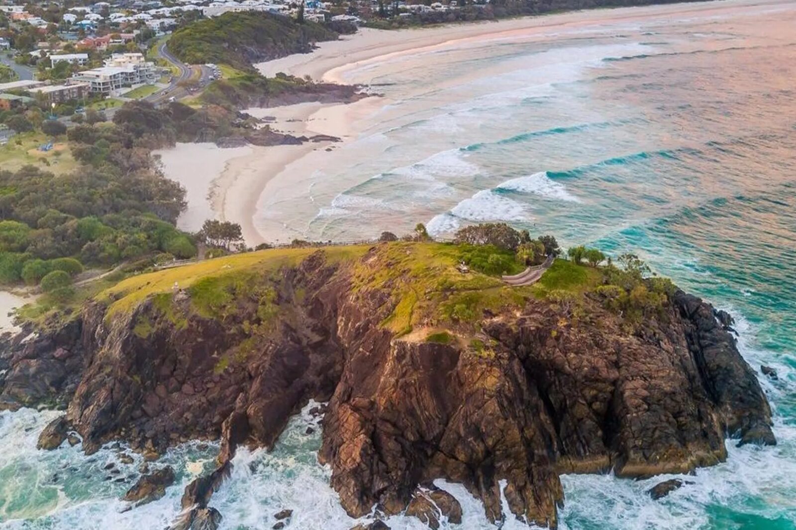 Surf breaking over coastal rocks from above